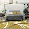 Image de Tapis effet laineux motifs arches jaune et gris 160x230