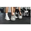 Image de Kettlebell 18 kg gris - REBEL - Fond plat - Poignée ergonomique - Prise ferme - Construction solide - Durable